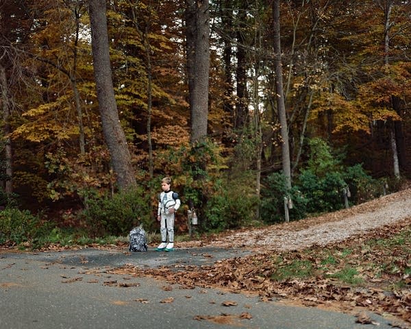 Children wait for their morning bus to school. 