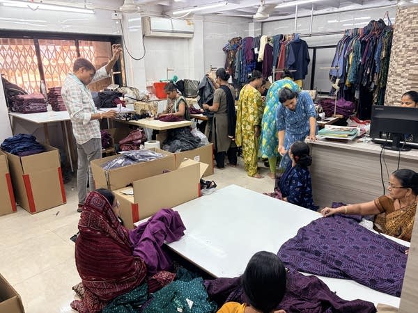 People sewing, doing quality checks, and working at desks.