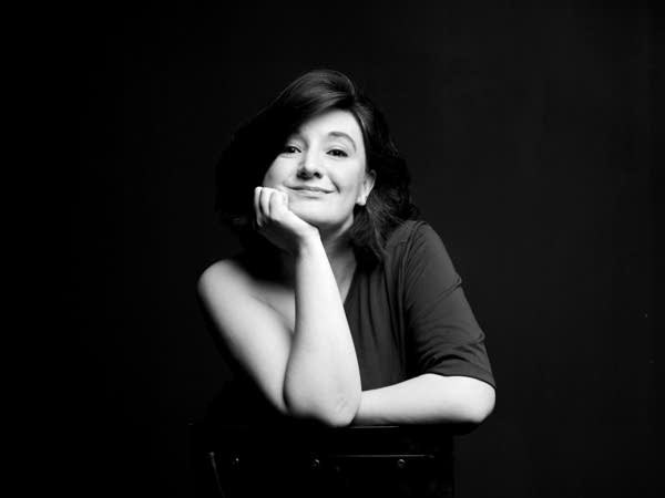 Poster A woman poses casually with her chin in her hand