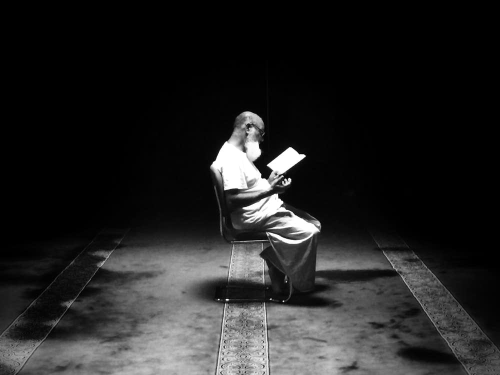 A Muslim man reads the Koran