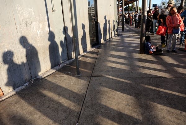 TIJUANA, MEXICO - MARCH 22: People wait in line on their way to cross the southern border into the United States near the San Ysidro Port of Entry on March 22, 2022 in Tijuana, Mexico. March 21 marked the two-year anniversary of Title 42, the controversial pandemic-era border policy enacted by President Trump, which cites COVID-19 as the reason to rapidly expel asylum seekers at the U.S. border. Title 42 remains in effect with the Biden administration facing pressure from Democrats to end its use.