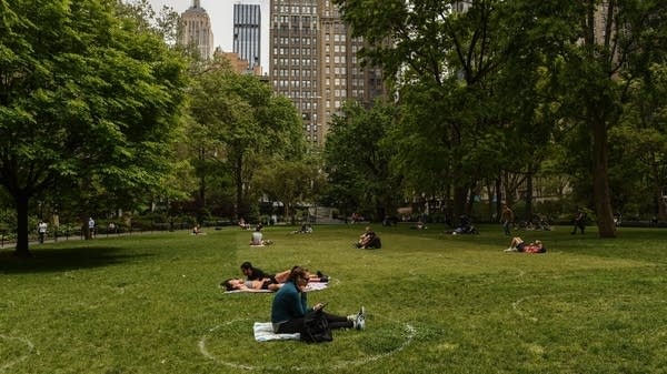 NEW YORK, NY - MAY 22 :  People sit inside painted circles for social distancing on May 22, 2020 In Madison Square Park in New York City. New York City is currently in its ninth week of lockdown and governmental guidelines on wearing a mask in public and social distancing are in effect. (Photo by Stephanie Keith/Getty Images)