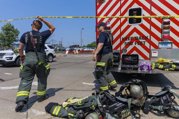 Crews block off an area on a street.