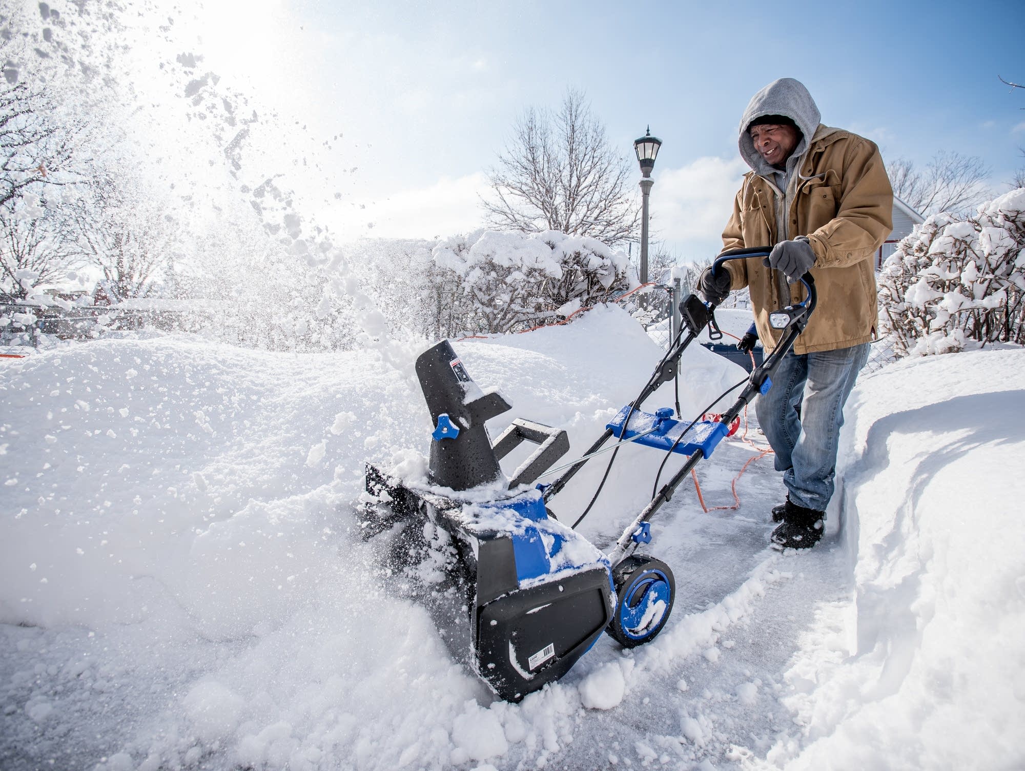 Danny Barber, 69, of St. Paul, uses a snowblower