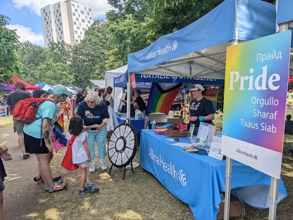 A woman and child visit a health booth