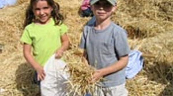 Amy and Ian work on making a scarecrow at the Pumpkin Harvest Festival in Glendale, Colo.