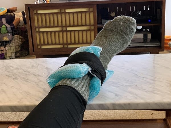 Luke's injured ankle in an ice pack