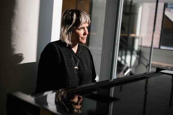 nona invie posing for portraits at a piano