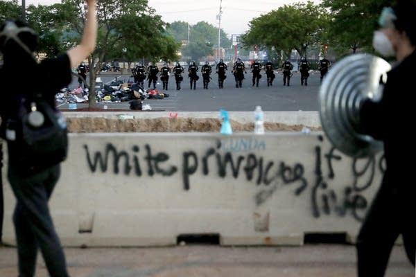 Police approach protesters.