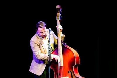A musician plays bass onstage