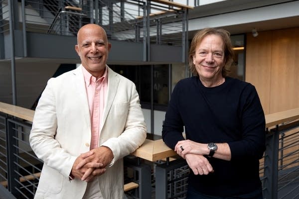 two men smiling for a portrait