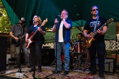 a rock band performing on an outdoor stage