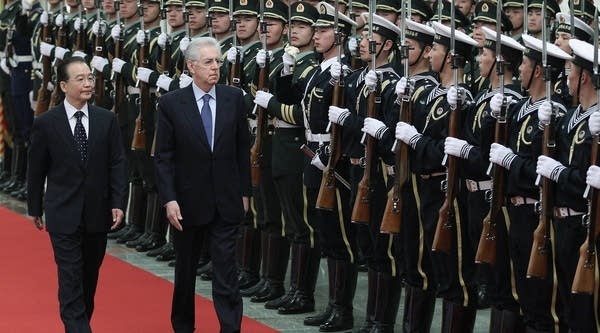 Chinese Premier Wen Jiabao accompanies Italian Prime Minister Mario Monti to view an honor guard during a welcoming ceremony at the Great Hall of the People on March 31, 2012 in Beijing, China.