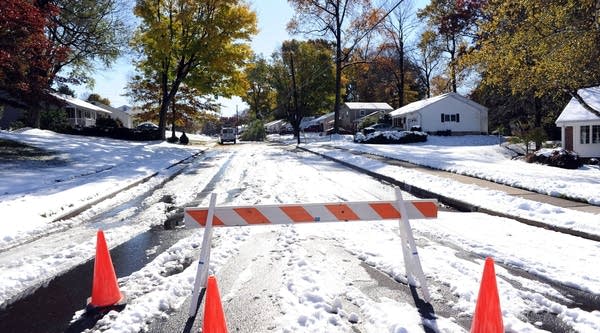 A tree rests upon power lines after a winter storm October 30, 2011 in Hartsville, Penn.