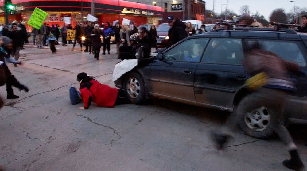 A car plows through the protesters