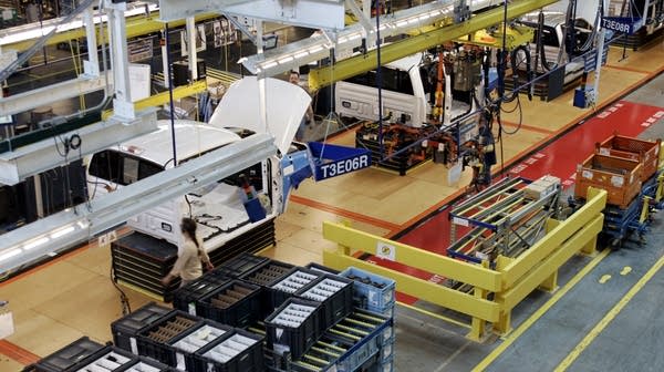 Assembly line workers in a Ford factory