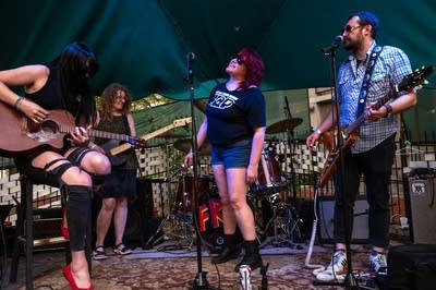 a rock band performing on an outdoor stage
