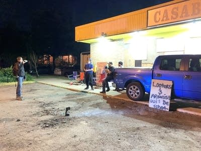 Several people are guarding Casablanca Foods. 