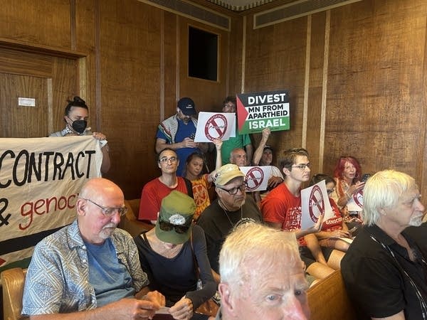 People protest at a meeting