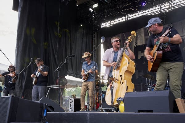 A string band performing on an outdoor stage