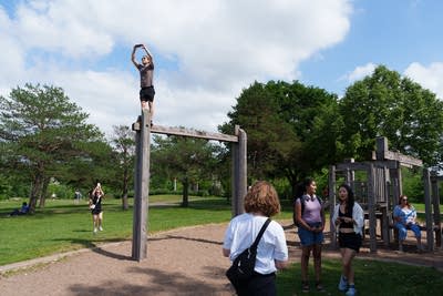 A man stands on top of a playground structure 