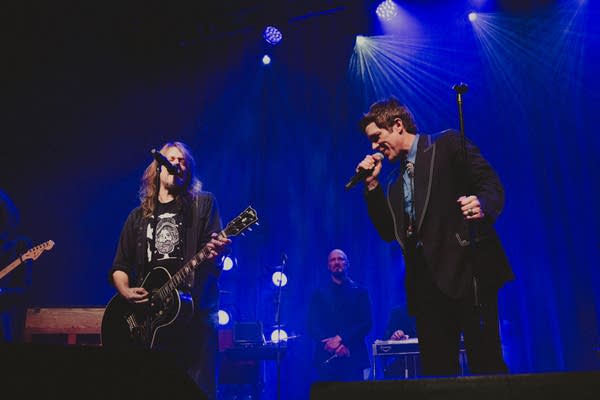 Two musicians performing together onstage