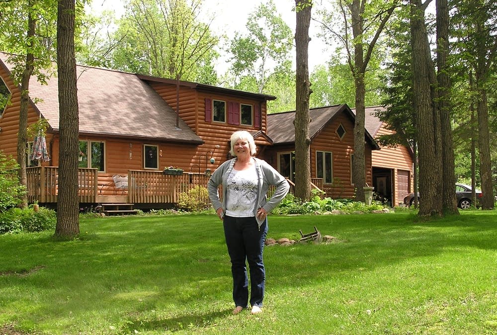 Jan Gertzen stands outside her home