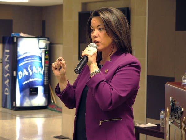 Congresswoman Angie Craig talks at a town hall at Burnsville High School