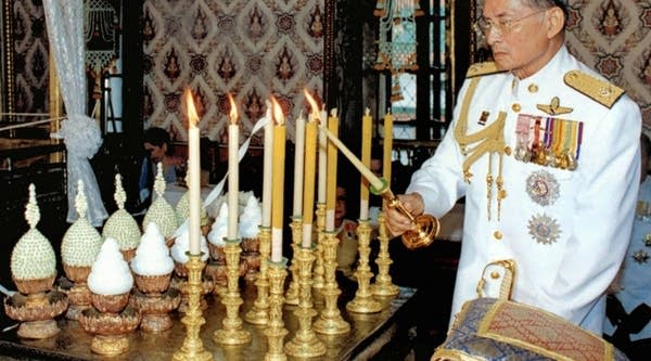 Thai King Bhumibol Adulyadej lights candles during a making ceremony ahead of his Coronation Day at the Grand Palace in Bangkok back in 2006.