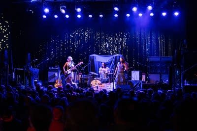 A band performing onstage in a music venue