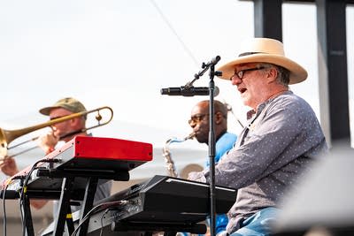 A band performing on an outdoor stage