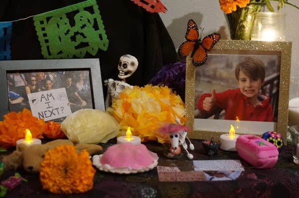 A Day of the Dead ofrenda with a framed photograph of a young boy.