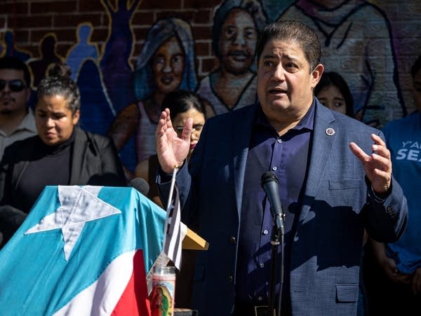 A man speaks at a podium