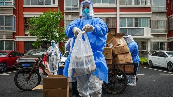 A volunteer clad in safety gear delivers food during the lockdown while Shanghai residents were not allowed to leave their apartments.