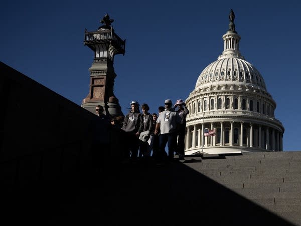 A tour group goes down a flight of stairs to the US Capitol Visitors Center at the US Capitol in Washington, DC on November 13, 2025, a day after the US Government reopened. The US government was set to take the first tentative steps towards re-opening on Thursday after President Donald Trump signed a bill to end the longest federal shutdown in US history. (Photo by ANDREW CABALLERO-REYNOLDS / AFP) (Photo by ANDREW CABALLERO-REYNOLDS/AFP via Getty Images)          