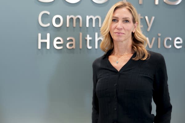 A woman in black shirt poses for photo