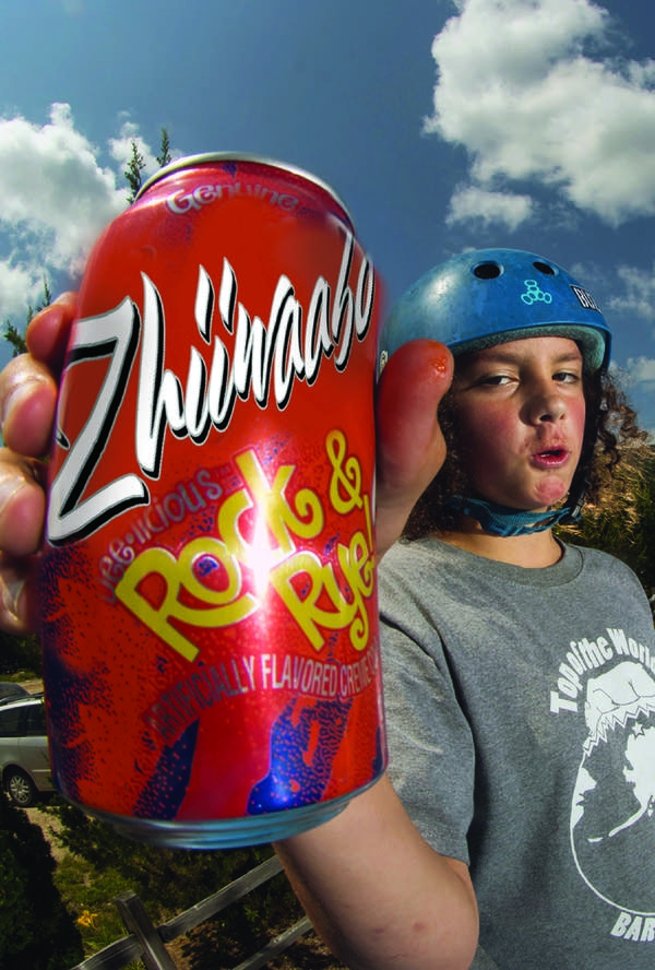 A person holds a soda can.