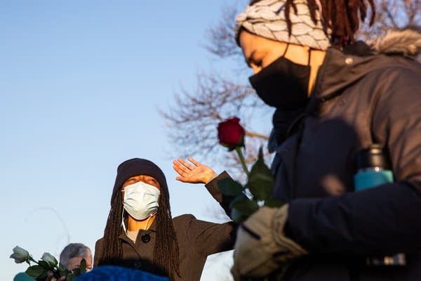 A woman puts her hand in the air.