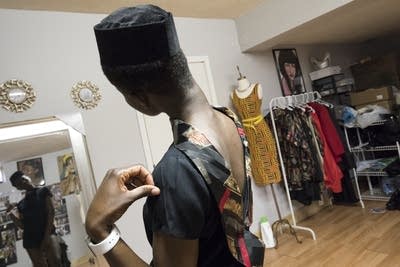 Model Setor Nyendu checks out a new look in the mirror during a fitting.