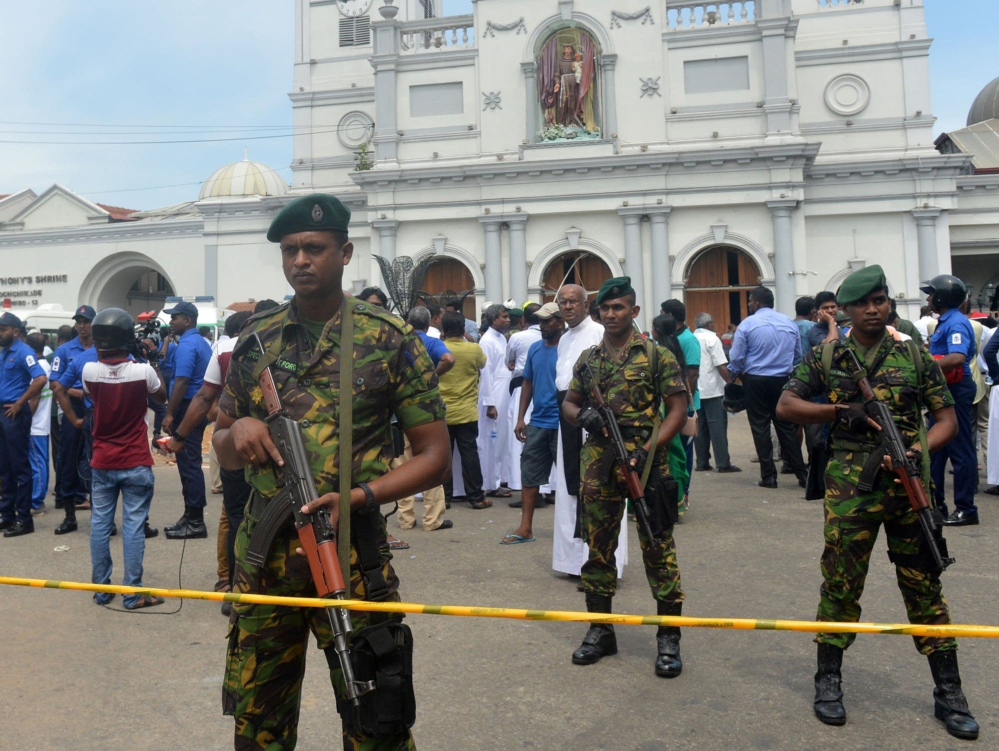 Sri Lankan security personnel keep watch outside a church