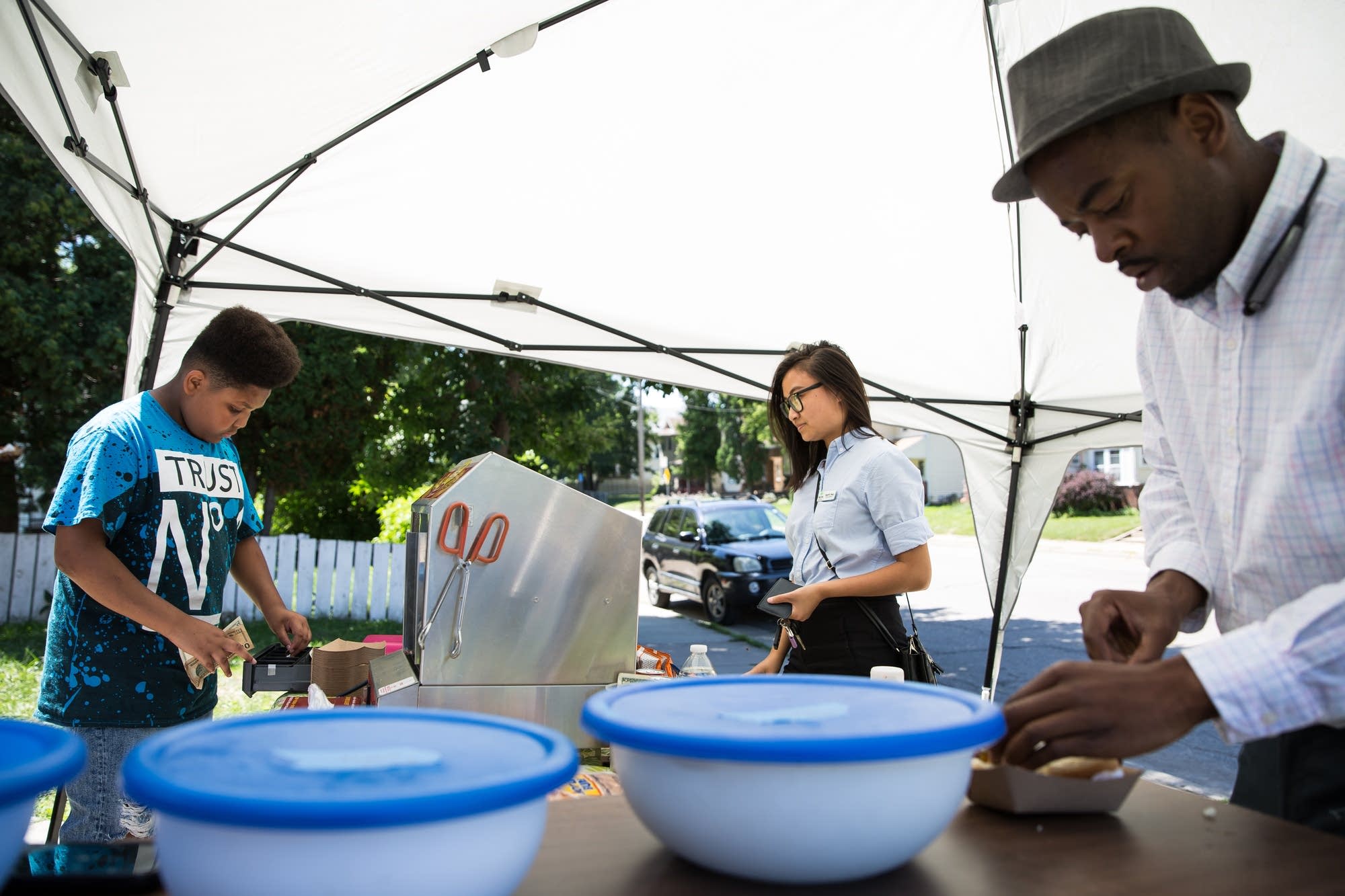 Jaequan Faulkner serves customers from a stand in front of his house.