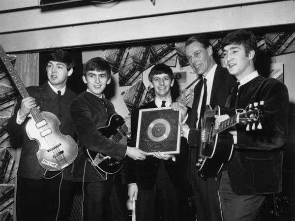The Beatles in 1963 with their first silver record. From left: Paul McCartney, George Harrison, Ringo Starr, producer George Martin and John Lennon.