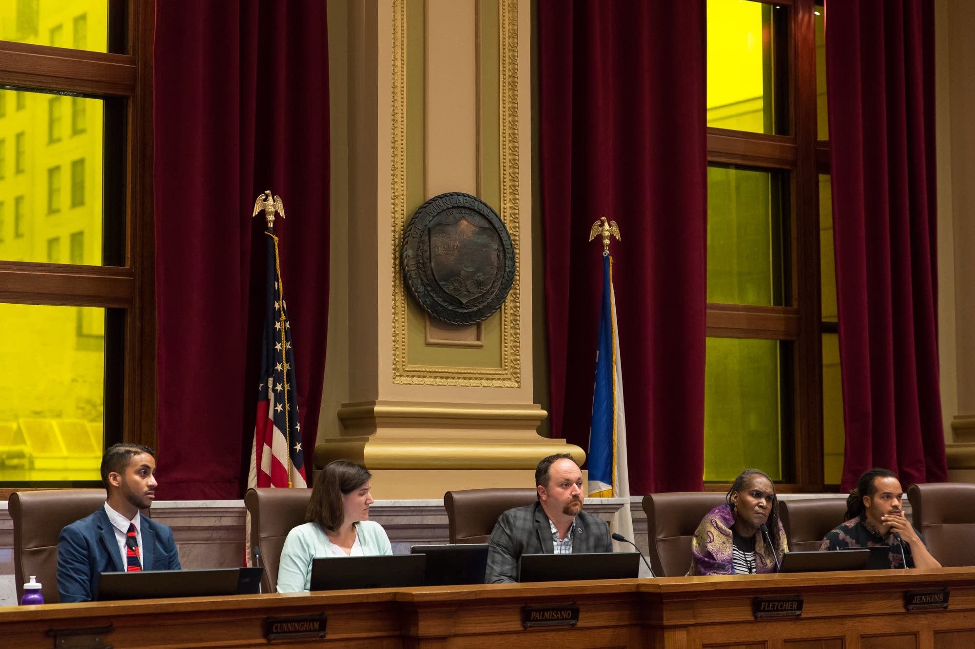City council members listen to a public statement.