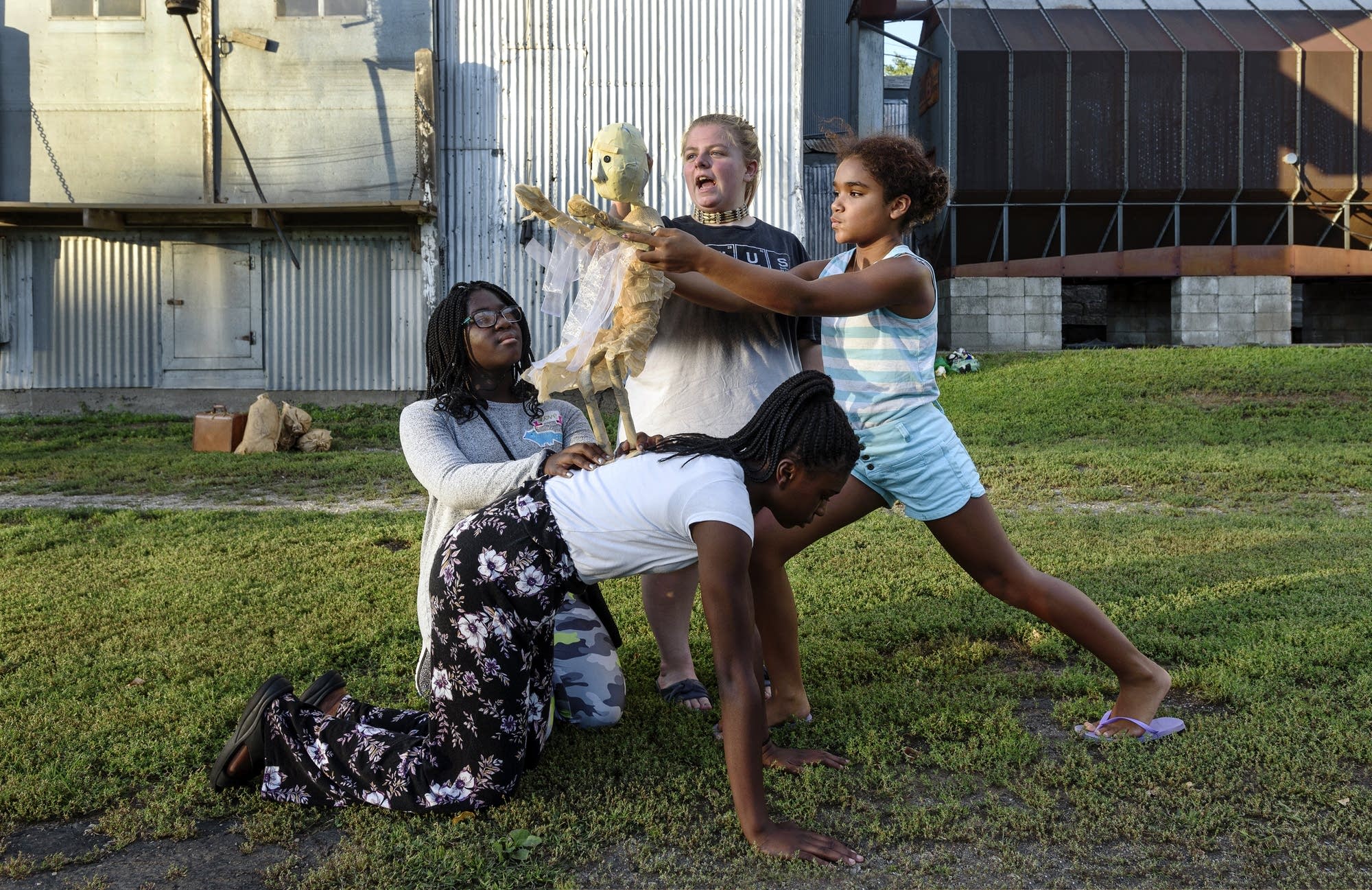 Local youth act out a scene with a puppet representing Minnesota Woman