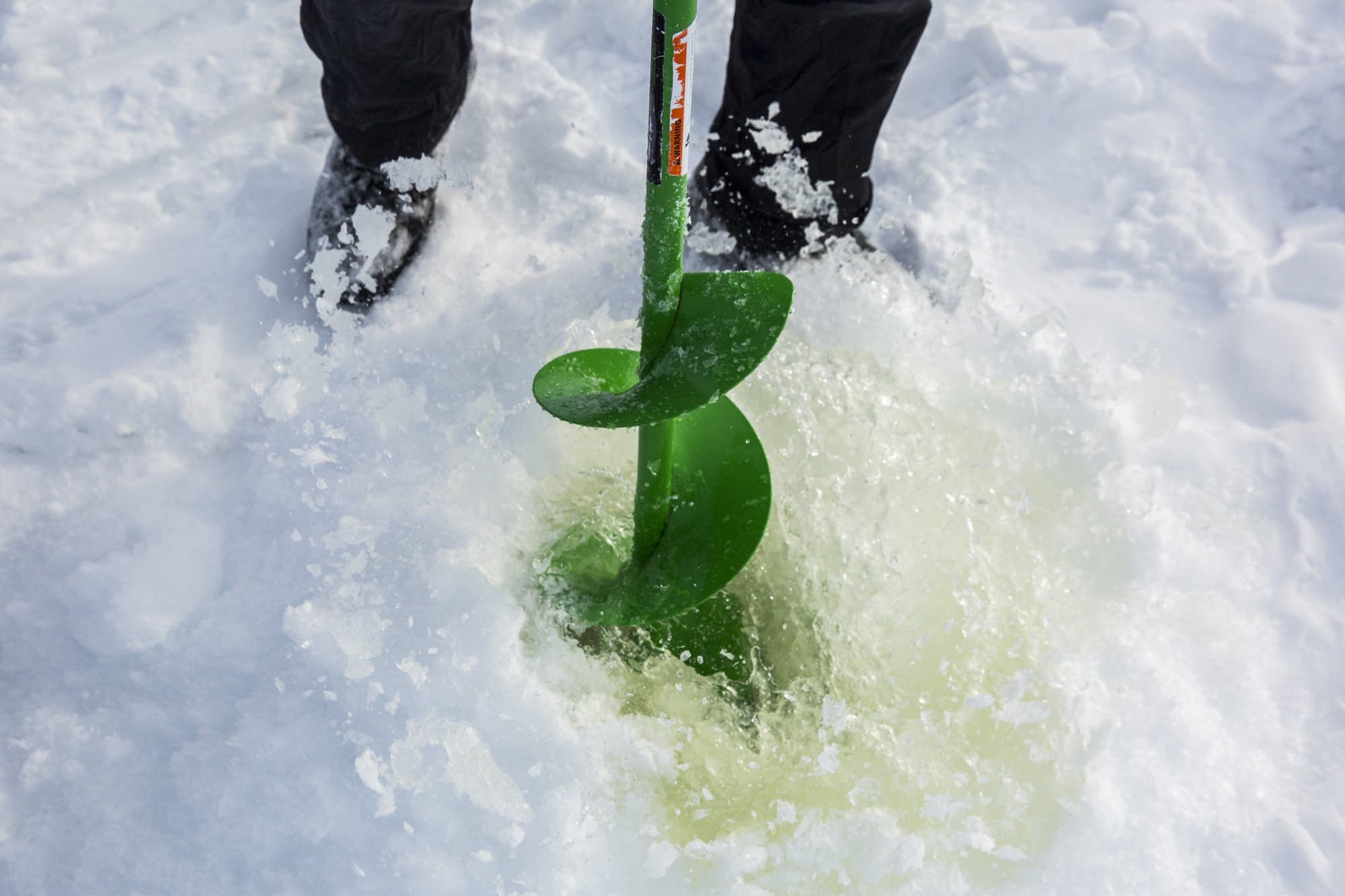 An auger is used to drill a hole into Lake Minnetonka