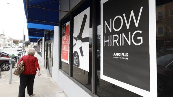 SAN FRANCISCO, CALIFORNIA - SEPTEMBER 16: A pedestrian walks by a now hiring sign at a Lamps Plus store on September 16, 2021 in San Francisco, California. Unemployment claims inched up to 332,000 from a pandemic low of 312,000 a week before. (Photo by Justin Sullivan/Getty Images)