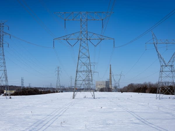 Electrical lines and towers frame a power plant