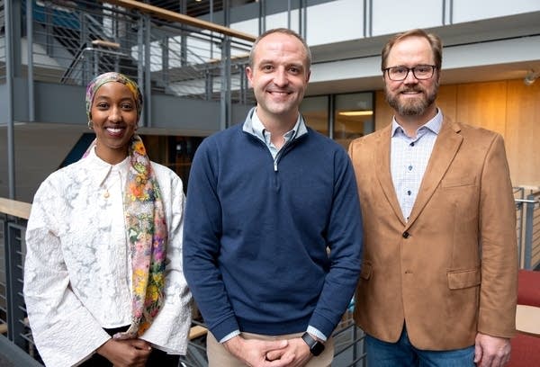 three people posing for a portrait