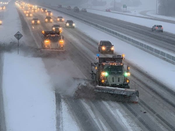 Snowplows on a snow-covered highway.