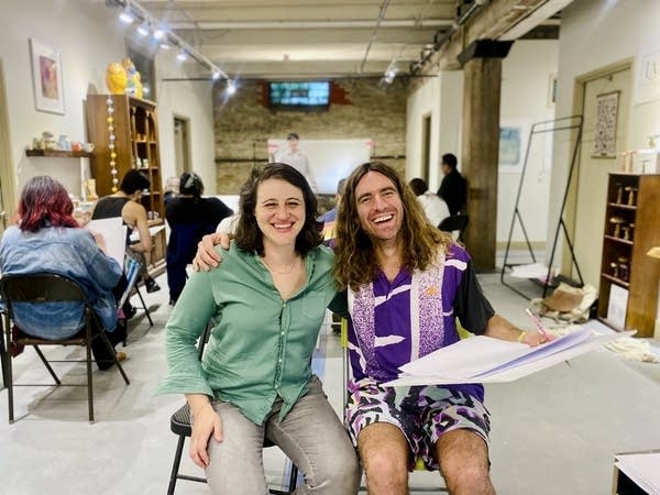 Two people smile for a photo